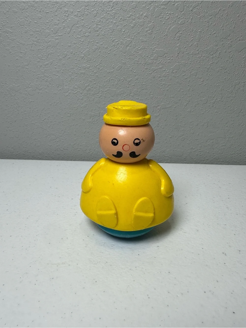 Fisher-Price Yellow Roly-Body Toy with Peach Face and Blue Base
